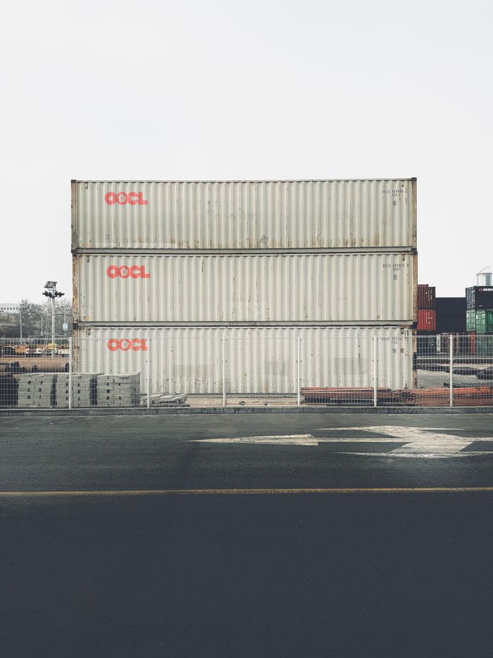 Stacks of shipping containers at Tianjin Port, China, depicting cargo logistics.